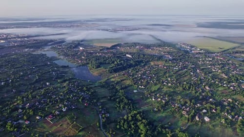 Sunrise with Fog Above Village in Morning