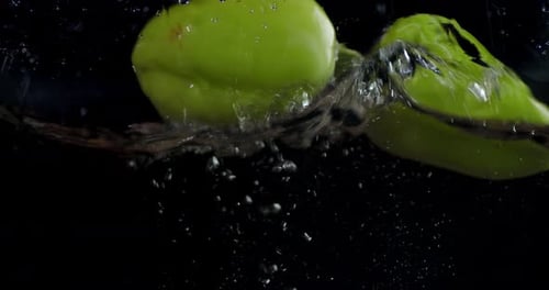 Fresh Green Peppers Submerged in Crystal Clear Water