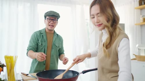 Couple Cooking Together in Bright Kitchen
