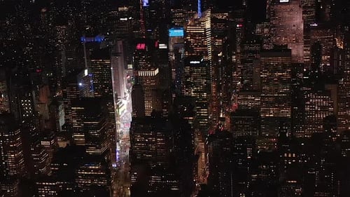 AERIAL: Breathtaking Wide View the Iconic Empire State Building Above Lit Up Parallel Avenues and