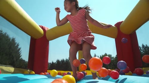 Girl bouncing in inflatable play house, super slow motion