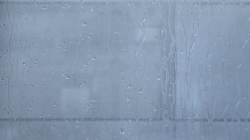 Water Flow Down on Glass Wall in Shower