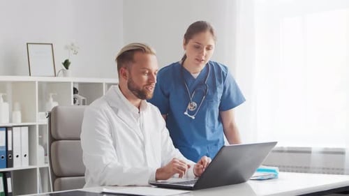 Professional medical doctors working in hospital office. Physician and the young nurse.