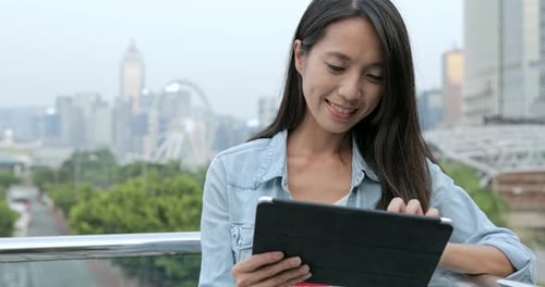 Woman Using Digital Tablet Computer in The City