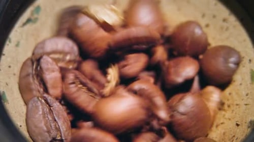 Coffee Beans Being Ground in Metal Grinder