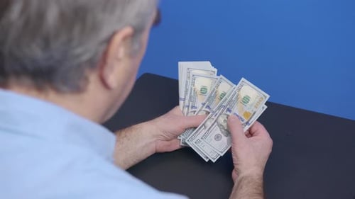 Counting Stack of One Hundred Dollar Bills