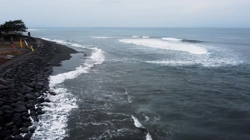Drone Flying Along the Black Sand Beach