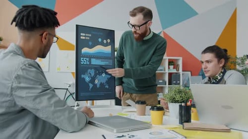 Team Meeting Analyzing Company Growth in Office