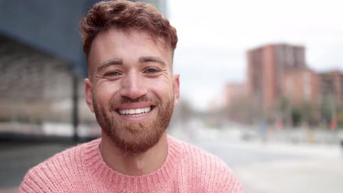Smiling Young Adult with Reddish-Brown Hair