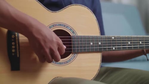 Close Up Of Man'S Hands Playing A Guitar At Home