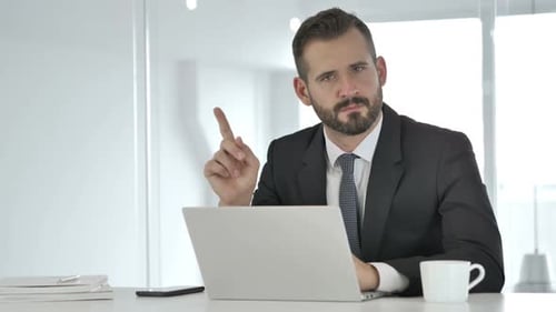 Serious Businessman Shakes Finger at Camera