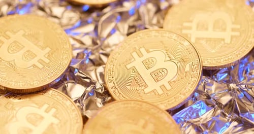 Gold Bitcoins on Shiny Metallic Foil