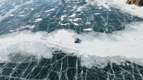 Hovercraft Gliding on Beautiful Frozen Ice Surface of Baikal Lake in Winter in Russia