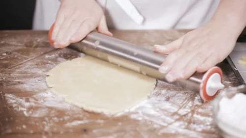 Woman Rolling Cookie Dough in Kitchen