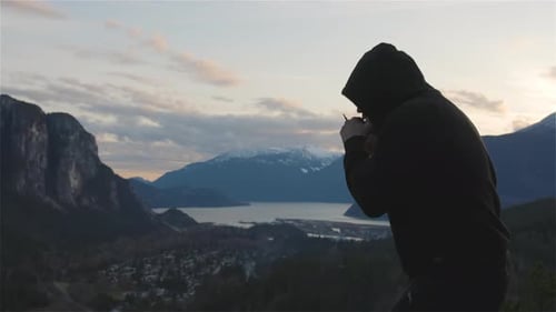Man Shadow Boxing on Hill at Sunrise
