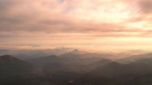 4K aerial view from a drone flying over the valley, fog in the morning.