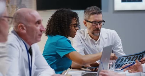 Medical Professionals Reviewing X-Ray in Meeting