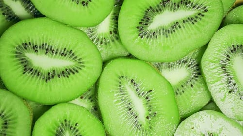 Slow Motion of Rotation Ripe Green Sliced Kiwi