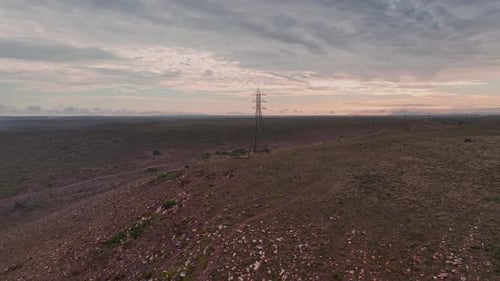 Rural Plains with Power Lines at Sunset