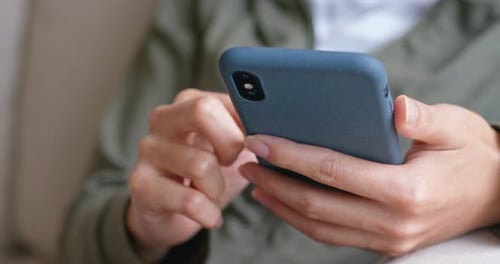 Hands Scrolling on Mobile Phone Close Up