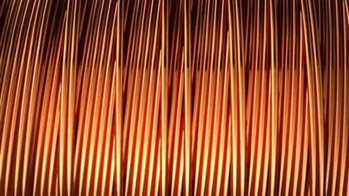 Close up of pure copper wire on the spool. Used in the electrical industry.