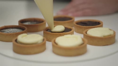 Decorating Chocolate Tarts with Cream