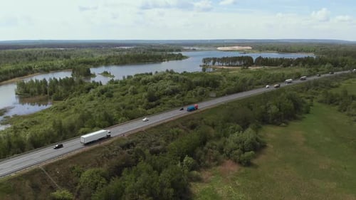 Aerial View of White Truck Passing Busy Highway Overpass Overdrive Bridge