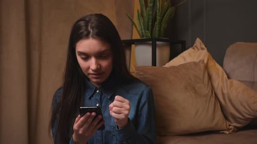 Young Woman Using Smartphone Indoors