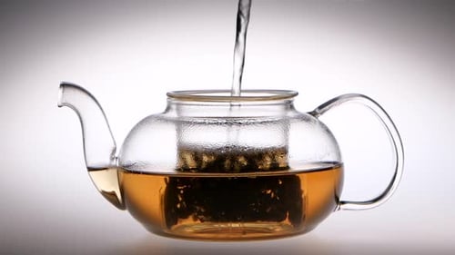 Slow Motion. Tea Is Brewed in a Glass Teapot. Studio