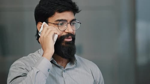 Man Talking on Smartphone in Office Setting