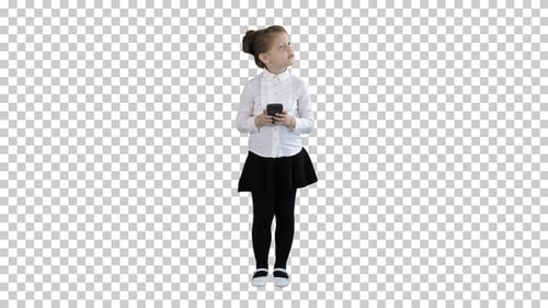 Cute little girl looks in smartphone and, Alpha Channel