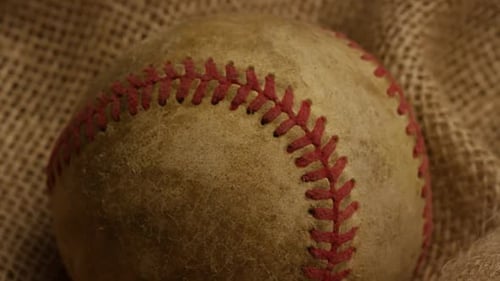Close Up of Worn Baseball on Burlap