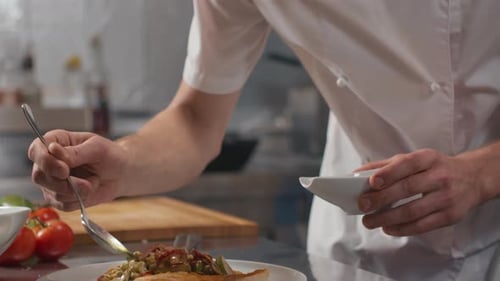 Chef Plates Salmon in Kitchen