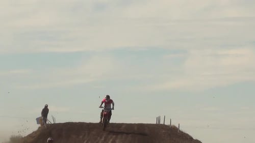 Motocross Racers Jumping Dirt Hill Outdoors
