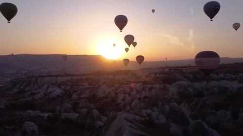 Aerial flies towards Hot air Balloons during sunrise, Cappadocia, Turkey