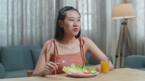 Young Adult Woman Eating a Healthy Salad