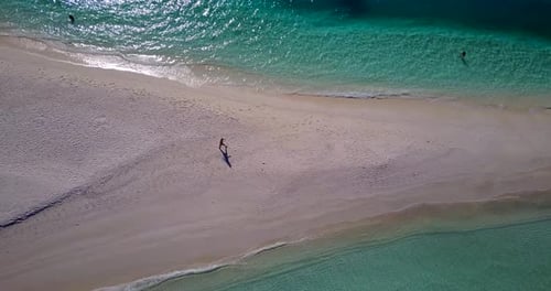 Daytime fly over tourism shot of a summer white paradise sand beach and blue water background in vib