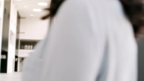 Smiling Young Man Using Smartphone in Office Lobby