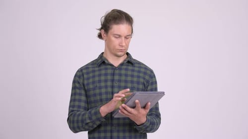 Man Using Tablet Device in Studio Setting