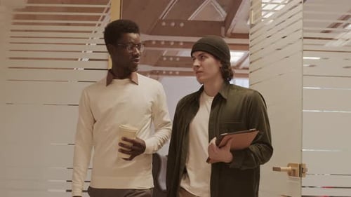 Two Diverse Businessmen Going along Office