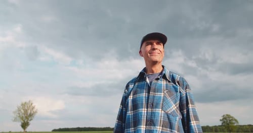 Farmer Using Digital Tablet While Examining Field