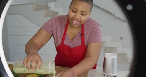 Woman Making Green Smoothie in Home Kitchen