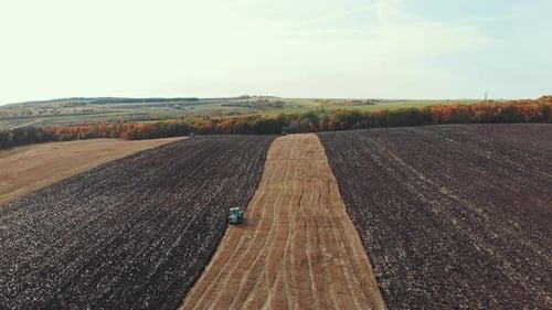 A View of Fields and Sky - Tractors Plows the Field