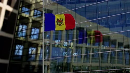 Moldova National Flag Waving in Front of Modern Glass Building