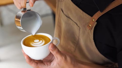 Barista Pouring Milk Creating Latte Art