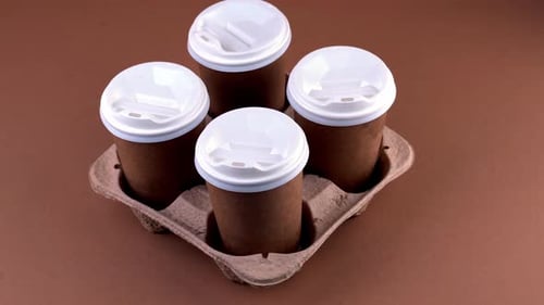 Four Coffee Cups with Lids in Carrier