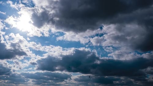 Dramatic Clouds Moving Slowly Across a Blue Sky