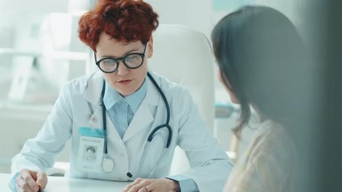 Doctor Consulting with Patient at Medical Office