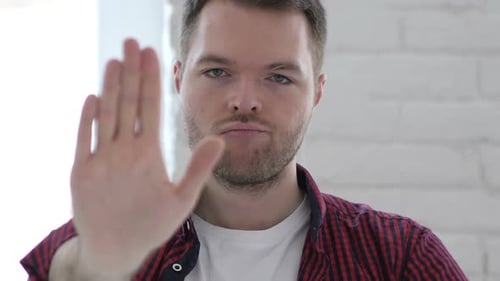 Young Adult Making Stop Hand Gesture
