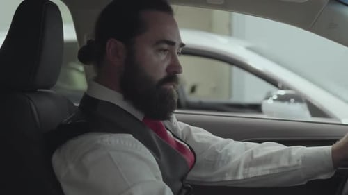 Man Holding Car Steering Wheel in Car